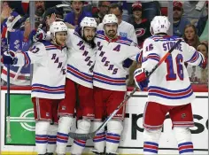  ?? KARL B. DEBLAKER — THE ASSOCIATED PRESS ?? The New York Rangers' Adam Fox, from left, Mika Zibanejad, Chris Kreider and Ryan Strome celebrate a goal Monday by Kreider in Game 7in Raleigh, N.C.