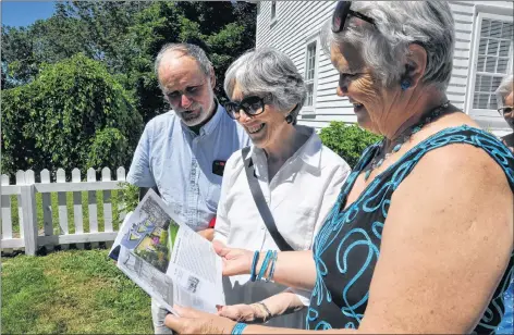  ?? SARA ERICSSON ?? Michal Crowe and Linda Forbes smile as they leaf through ‘‘Witnesses to a New Nation,” a book they compiled with photos from the Heritage Trust exhibit of the same name that travelled around Nova Scotia.