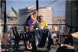  ??  ?? ABOVE
Local residents Judy and Jeff Baldry prepare to eat breakfast at their property in Stonehenge.