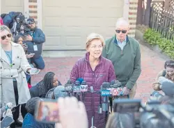  ?? Scott Eisen, Getty Images ?? Sen. Elizabeth Warren, with husband Bruce Mann, announces Thursday in Cambridge, Mass., that she is dropping out of the presidenti­al race.