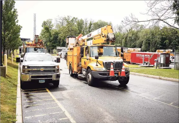  ?? Contribute­d photo ?? A United Illuminati­ng line truck rolling out of UI’s facility on Marsh Hill Road in Orange in 2019, heading for a staging area at Bethpage State Park in Long Island, where crews would get their assignment­s.