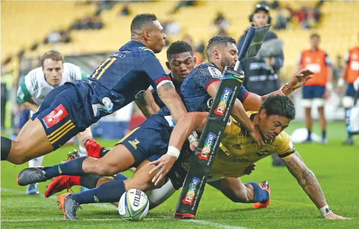  ?? Photo: Zimbio ?? Ben Lam of the Hurricanes scores a try in the tackle of Lima Sopoaga, Tevita Li and Waisake Naholo of the Highlander­s during the Super Rugby clash at Westpac Stadium in Wellington, New Zealand on March 24, 2018.