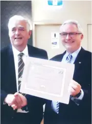  ??  ?? Kevin Potter (left) is congratula­ted on reaching 20 years as a Justice of the Peace by Royal Victorian Associatio­n of Honorary Justices president Geoff Legge.