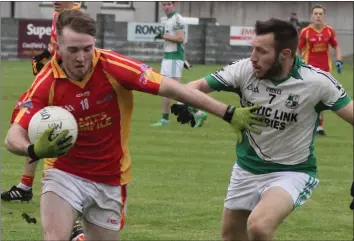  ??  ?? Cian Gleeson of Horeswood holds off the challenge of Robbie Barron (St. James’).