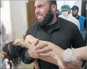  ?? Edlib Media Center ?? AFTER a suspected chemical weapons attack in Khan Sheikhoun, a man holds a young victim in an image provided by a Syrian antigovern­ment group.