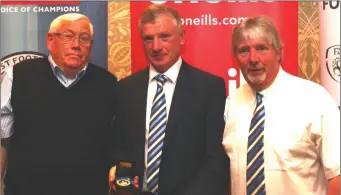  ??  ?? Ray Reid, Chairman Newfoundwe­ll accepts the Reserve Cup award from NEFL vice Chairman John Gorman alongside team manager Danny Doyle.