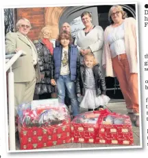  ??  ?? Left, Joseph and Darcey hand over their hampers to Shoreline Food Bank, Southport
