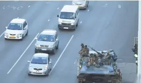  ?? AP ?? A military tank is seen with armed soldiers outside President Robert Mugabe’s office in Harare yesterday.