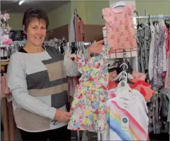  ?? PHOTO: Kieren Tilly ?? MORE THAN MEETS THE EYE: Diane Worthingto­n with just a few examples of the baby and children’s clothing available at West End Lotto and Wool in Wangaratta.
