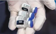  ?? EDDIE MOORE/JOURNAL ?? Vials containing five doses each of the Pfizer COVID-19 vaccine fresh out of a freezer.