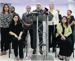  ?? DAVE ABEL / POSTMEDIA NEWS ?? Darryl Singer, a lawyer with Diamond and Diamond law, with the victims of the bombing as he announces a lawsuit against the Bombay Bhel in Mississaug­a, Ont.