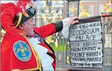  ?? JONATHAN BRADY/PA VIA AP ?? Town Crier Tony Appleton holds a scroll outside Green Park in central London near Buckingham Palace Monday after it was announced that Prince Harry and Meghan Markle are engaged.