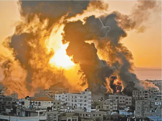  ?? Youssef Massoud / AFP ?? A fire rages at sunrise in Khan Yunish following an Israeli air strike on targets in the southern Gaza Strip midweek.