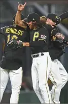  ?? Joe Sargent/Getty Images ?? Bryan Reynolds (10), Cole Tucker (3) and Ben Gamel (18) celebrate keeping the good times rolling at PNC Park with the Pirates’ 3-2 win over the Detroit Tigers Tuesday.