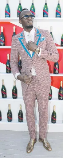  ??  ?? Usain Bolt is dressed for success at Oaks Day. .
