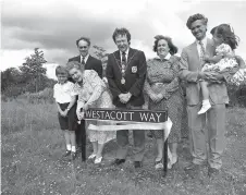  ?? ?? Florence Westacott cut the ribbon for Westacott Way – named in memory of her husband – in the company of family members and the mayor in 1992. Ref:134757-5