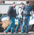  ?? Picture: ALISON WYND ?? Police carry a taxidermy turtle after the July theft.