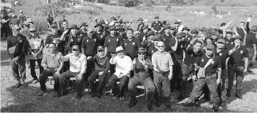  ??  ?? Paulus (seated third left) with Sylvester on his left and Paul, next to Sylvester, join other GOF Limbang personnel and villagers in a group photo at the Catholic cemetery