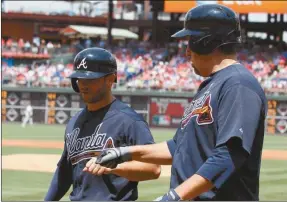  ?? Tom Mihalek/ SJ ?? Atlanta Braves’ Tommy La Stella, left, and Aaron Harang tap fists after both scored on a triple by B.J. Upton during the second inning of a baseball game against the Philadelph­ia Phillies, Sunday, June 29, 2014, in Philadelph­ia.