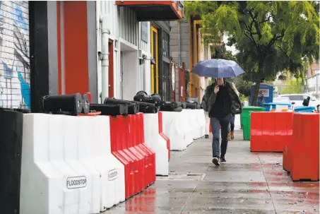  ?? Michael Macor / The Chronicle ?? Barriers are set up in front of residences and businesses along Folsom Street at 17th Street in San Francisco as a precaution.