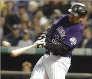  ?? DAVID ZALUBOWSKI - THE ASSOCIATED PRESS ?? FILE - In this Wednesday, June 30, 2004 file photo, Colorado Rockies’ Larry Walker connects for a double on a pitch from Milwaukee Brewers starting pitcher Ben Sheets in the fourth inning in Denver.