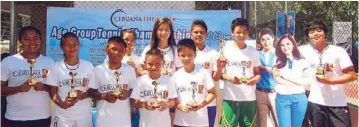  ??  ?? Winners of the Cebuana Lhuillier National Age Group Tennis Series leg in Midsayap, North Cotabato hold their trophies during awards rites with local bets Jazelle Madis, Abson John Alejandre and Alliah Elline Ragunton bagging two titles each. Madis...