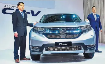  ??  ?? Latest offering: Project leader of the all-new Honda CR-V, Daigo Ito (left) and Hayashi with the newly launched fifth-generation Honda CR-V.