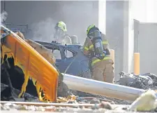  ??  ?? Images of the crash site taken in the aftermath of the accident. Inset, below: smoke billows from the impact site.