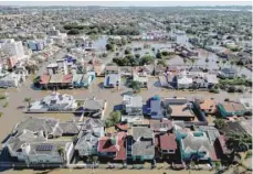  ?? — AFP ?? Aerial view of a flooded area of Canoas, a municipali­ty north of Porto Alegre, Brazil.