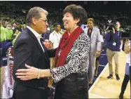  ?? Robert Franklin / Associated Press ?? UConn coach Geno Auriemma, left, and Notre Dame’s Muffet McGraw shake hands before Sunday’s game in South Bend, Ind. UConn won 89-71.