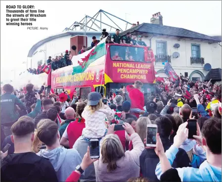  ?? PICTURE: Alamy ?? ROAD TO GLORY: Thousands of fans line the streets of Wrexham to greet their title winning heroes