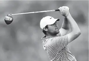  ?? Michael Reaves, Getty Images ?? Scottie Scheffler plays his shot on the 13th tee in his match against Jon Rahm during the World Golf Championsh­ips-Dell Technologi­es Match Play at Austin Country Club on Saturday in Austin, Texas.