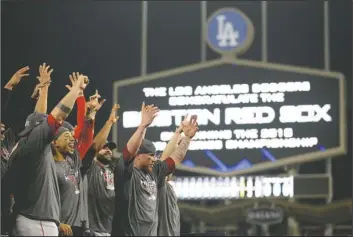  ?? The Associated Press ?? IN FIVE: The Boston Red Sox celebrate after Game 5 of the World Series against the Dodgers on Sunday in Los Angeles. The Red Sox won, 5-1, to win the series, 4-1.