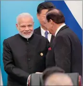  ??  ?? Prime Minister Narendra Modi gets a moment with Pakistan's President Mamnoon Hussain at the Shanghai Cooperatio­n Organisati­on Summit in Qingdao. Chinese premier Xi Jinping's is in the background, chaperonin­g the two.