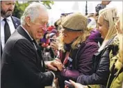  ?? KING CHARLES III Aaron Chown Pool Photo ?? meets with members of the public waiting to pay their respects to the queen.