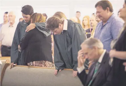  ?? COURTNEY SACCO/CORPUS CHRISTI CALLER ?? Santa Fe High School students join mourners at Arcadia First Baptist Church on Sunday, two days after 10 people at the school were killed. “We have fallen away from God,” the pastor told the congregati­on.