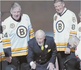  ?? AP PHOTO ?? THROWBACK TUESDAY: Bruins alums Terry O’Reilly, left, and Peter McNab flank their former coach Don Cherry as he drops a ceremonial puck prior to Tuesday night’s game against Calgary at TD Garden. It was part of a celebratio­n of the record-setting...