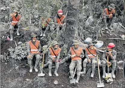  ?? Picture: AFP ?? RESCUE EFFORTS: Soldiers take a break during the search for victims of the Fuego Volcano in the ash-covered village of San Miguel Los Lotes, in Escuintla Department, about 35km southwest of Guatemala City, on Tuesday