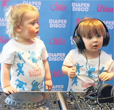  ??  ?? Two-yeAr-old Miller McDonald, left, and Jax Mann, one, get ready to boogie ahead of the ‘diaper disco’.