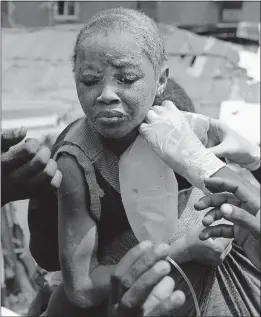  ?? [SUNDAY ALAMBA/THE ASSOCIATED PRESS] ?? A child is pulled from the rubble of a collapsed building Wednesday in Lagos, Nigeria. Rescue efforts continued late into the night. At least eight people were killed, but 70 were in the building when it collapsed.