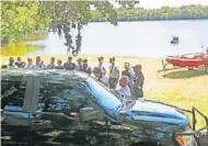  ?? RED HUBER/STAFF PHOTOGRAPH­ER ?? Authoritie­s prepare for a second day of searching an east Orange County pond, where they would find a young woman’s body.