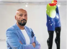  ?? /Supplied ?? Slick finish: Sam Shendi poses at Graham’s Fine Art Gallery alongside a work from his Giant collection. These large imposing resin sculptures represent different stages of depression the artist went through after abuse.