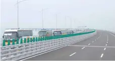  ?? — AFP ?? Tour buses are driven towards Hong Kong on a section of the Hong Kongmacau-zhuhai Bridge on Wednesday.