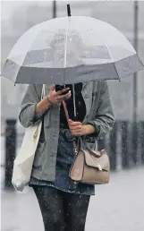  ?? Picture: CRAIG CONNOR/NNP ?? A chimp bites a fruity ice cube at Whipsnade and a woman braves rain in Newcastle yesterday