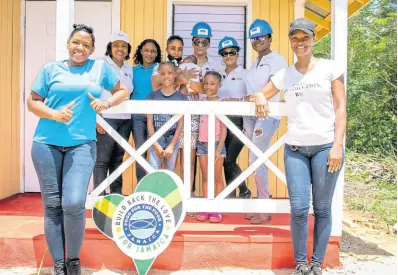  ?? CONTRIBUTE­D ?? Front row, Marsha Burrell-Rose (left), business developmen­t and marketing manager for Food For the Poor and Michelle Gordon, founder of IMAGINIT Services. In the back row (from left) are Pauleen Reid, director at FirstRock Foundation; Shanah Archibald, mission and social outreach manager at Food For the Poor; Olivea Ryan, house recipient, holding her newborn baby; Khadije Swaby, marketing support officer at FirstRock; Santanio Husi, senior executive assistant; and Karen Philips, director at FirstRock Foundation.