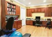  ?? Photo courtesy of Craftsmans­hip by John ?? This multifunct­ional home office with exercise area is by Craftsmans­hip by John Inc.