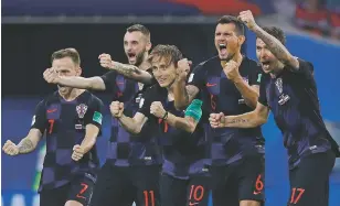  ??  ?? Croatia players celebrate after a penalty is saved in a shootout against Russia on Saturday during their World Cup quarterfin­al match in Sochi, Russia. Croatia won the match 4-3 on penalties after the game ended 2-2.