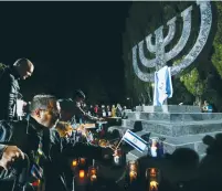  ??  ?? PEOPLE ATTEND a ceremony last year commemorat­ing the victims slain at Babi Yar in Kiev in 1941.