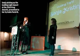  ??  ?? SONJA PICKING UP THE GUIDING LIGHT AWARD AT THE 2014 PROG AWARDS, PRESENTED TO HER BY KATIE PUCKRIK.