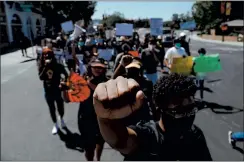  ??  ?? RANDY VAZQUEZ — STAFF PHOTOGRAPH­ER Josiah Cannon, 17, raises his fist during the March for Freedom in Santa Clara on Friday. The march began at Santa Clara University and ended at San Jose State.